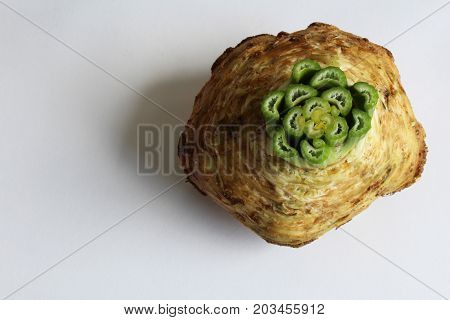 Single celery root with top cut off, horizontal aspect