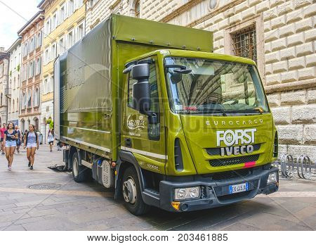 Trento Italy 14 Aug 2017 - A green Forst beer truck in the streets of Trento city. Forst beer is a famous south tyrolean beer brand