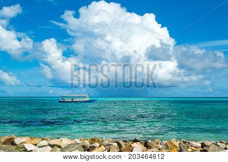 Wooden Maldivian traditional dhoni boat at sunny day on the turquoise Indian ocean water Maldives