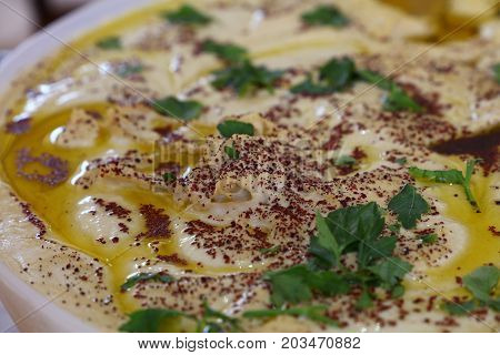 Hummus With Olive Oil And Parsley In A Bowl