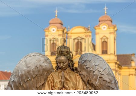 TIMISOARA ROMANIA - SEPTEMBER 8 2017: Living statue of a woman dressed with angel elements and present on the street inside the CheckART Carnival organized by the City Hall Timisoara. Union Square.