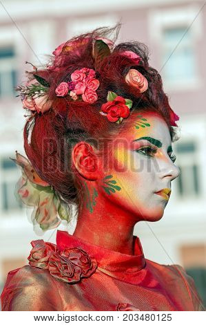 TIMISOARA ROMANIA - SEPTEMBER 8 2017: Portrait of living statue of a woman multicolor dressed and present on the street CheckART Carnival organized by the City Hall Timisoara. Union Square.