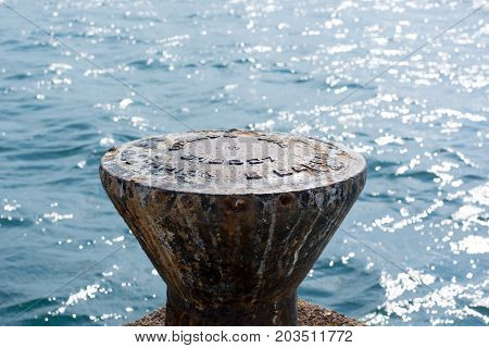 Dock Cleats On A Pier To Tie-up Boats With Blue Sea As The Background