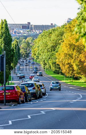 Northampton UK - Aug 15 2017: Cloudy Day Cityscape View of Northampton UK with road in foreground.