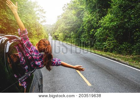 Asian women travel relax in the holiday. driving a car traveling happily.
