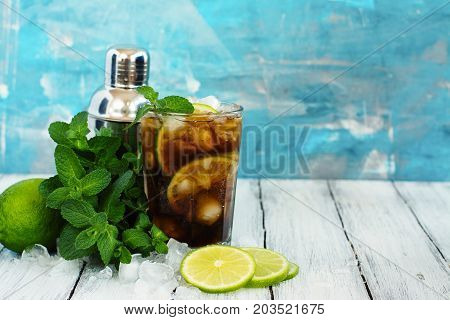 Summer cuba libre cocktail with lime and mint. Space for text