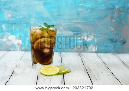 Summer cuba libre cocktail with lime and mint. Space for text