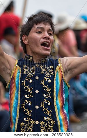 June 17 2017 Pujili Ecuador: indigenous quechua man fully engaged in dancing on the street during the Corpus Christi annual parade