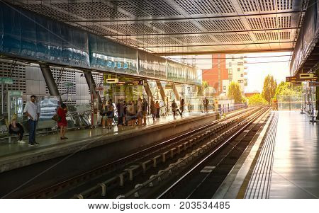 LONDON, UK - 25 August, 2017: Canary Wharf DLR station and people on the platform against of the sun light