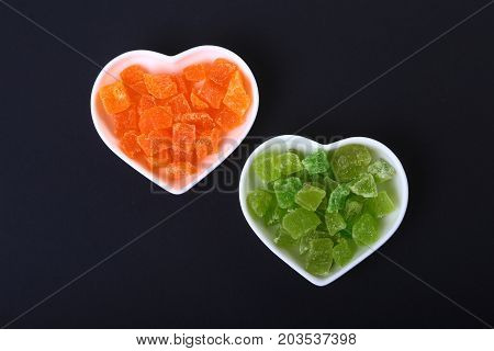 Delicious assorted dried organic fruit in bowl isolated on black background