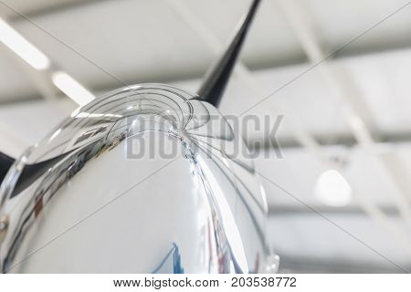 Detail of a propeller cone aircraft in a hangar.