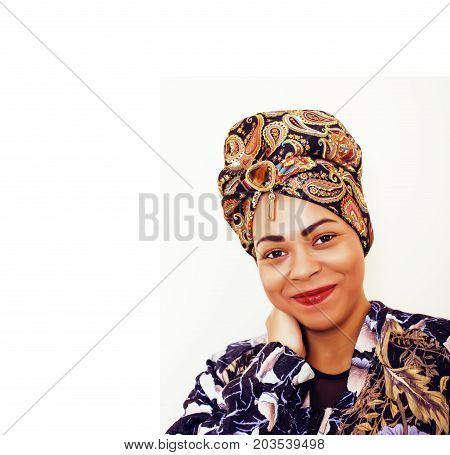 beauty bright african woman with creative make up, shawl on head like cubian closeup smiling, cheerful tan , lifestyle people concept close up