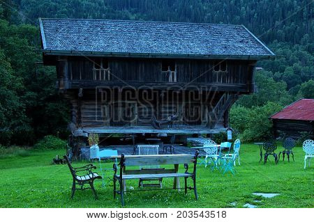 Old cabin in south of norway with alot of grass