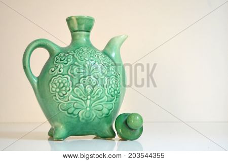 Green decorative kettle on white background - element decor