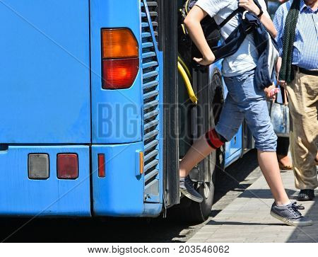 Blue bus at the stop in the city