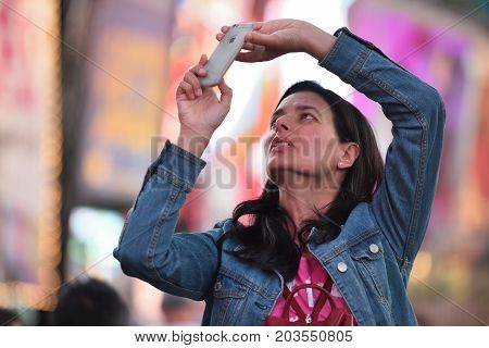NEW YORK CITY - AUG. 26 : Unidentified people on the Times Square in Manhattan on August 26 2017 in New York City NY. Times Square is a major tourist destination and entertainment center.