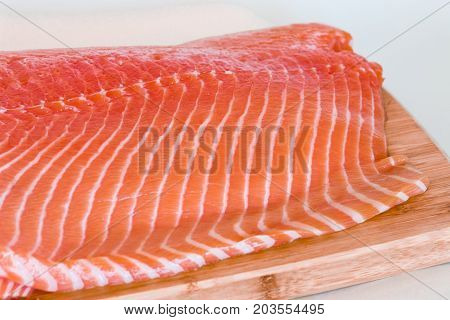 fresh raw salmon on wooden cutting board