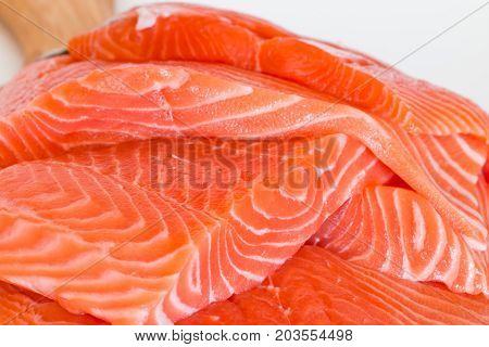 fresh raw salmon on wooden cutting board