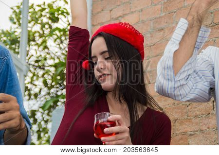 Young people holding glass talk in the party.