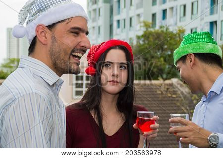 Young people holding glass talk in the party.