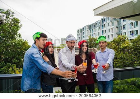 Young people holding glass talk in the party.