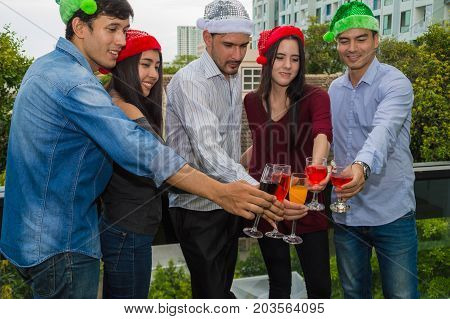 Young people holding glass talk in the party.