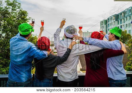 Young people holding glass talk in the party.