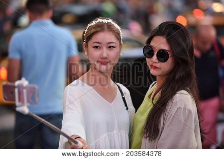 NEW YORK CITY - AUG. 26 : Unidentified people on the Times Square in Manhattan on August 26 2017 in New York City NY. Times Square is a major tourist destination and entertainment center.