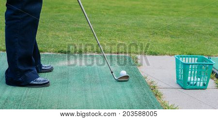 Golf Player At Tee Off On A Golf Course