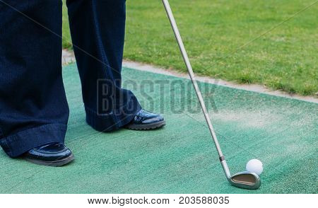 Golf Player At Tee Off On A Golf Course