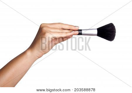 Women's hand with cosmetic accessories - powderbrush
