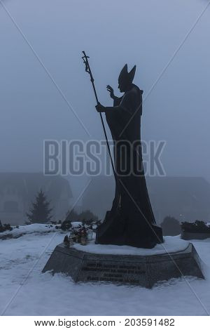 Mount St. Anna Poland - February 4 2016: Statue of Pope John Paul II in the winter fog in the Franciscan monastery on Mount St. Anna in Poland