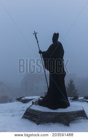 Mount St. Anna Poland - February 4 2016: Statue of Pope John Paul II in the winter fog in the Franciscan monastery on Mount St. Anna in Poland