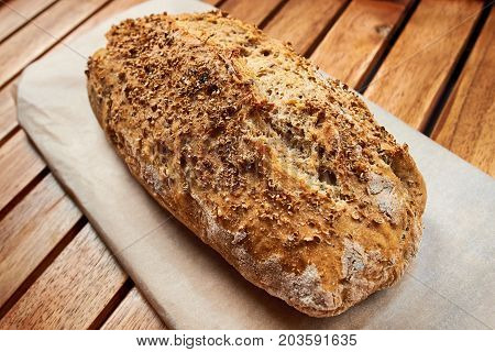 Loaf Of Homemade Bread Whit Coriander Seeds On Wooden Background, Food Closeup.