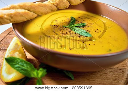 Turkish Traditional Lentil Cream Soup With Mint, Lemon And Homemade Bread. Ezogelin.