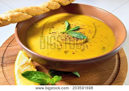 Turkish Traditional Lentil Cream Soup With Mint, Lemon And Homemade Bread. Ezogelin.