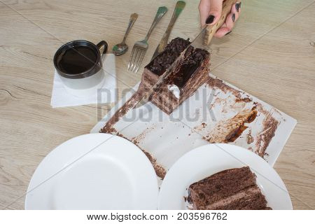 Coffee cup and chocolate cake onon wooden table. Coffee and a piece of cake.