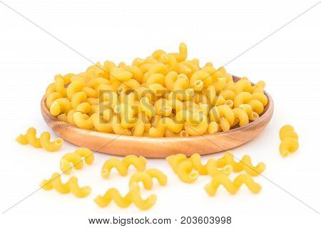 Raw Italian Macaroni Pasta on wooden plate.