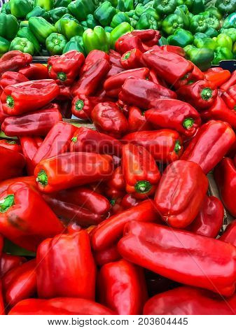 Fresh red and green peppers on display at the market.