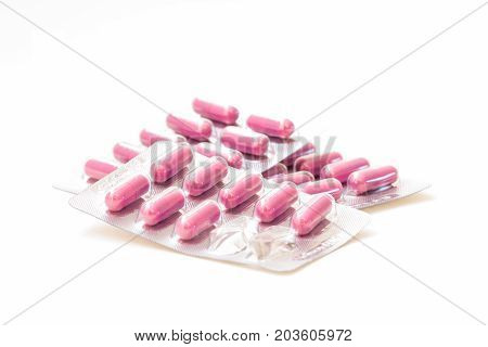Pills in blister pack closeup on white background.