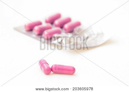 Pills in blister pack closeup on white background.