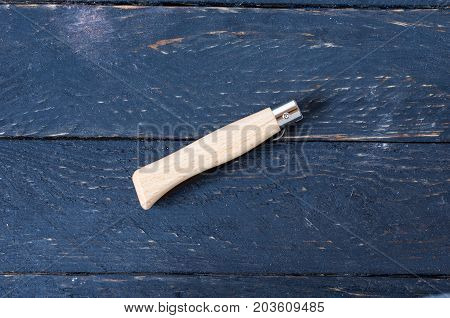 Knife In A Folded Form On A Black Background.