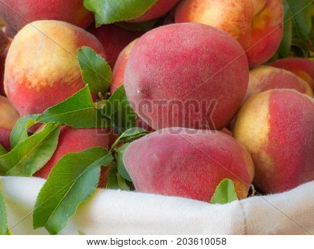 Ripe Peaches In Basket On Wooden Background.