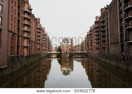 The famous Hamburg Wasserschloss water castle with the Wandrahmsfleet bridge in the Speicherstadt in Germany.