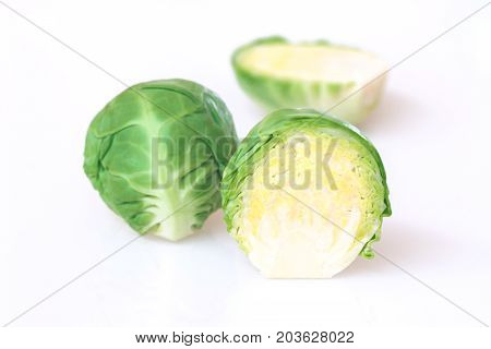 Close up of green brussel sprouts on white background.