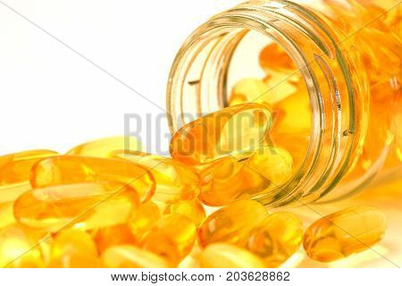 Fish oil omega 3 with vitamin D capsules good for heart health on a white backguound healthy diet concept