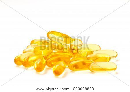 Fish oil omega 3 with vitamin D capsules good for heart health on a white backguound healthy diet concept