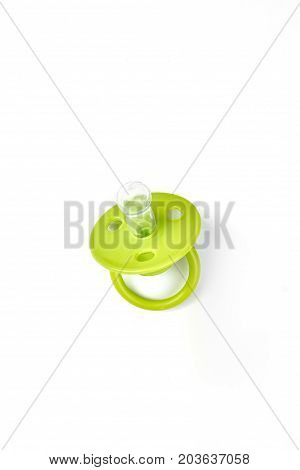 Baby silicone pacifier in green color. Baby green pacifier with rubber soother isolated on white background. Baby pacifier with ring on sale.