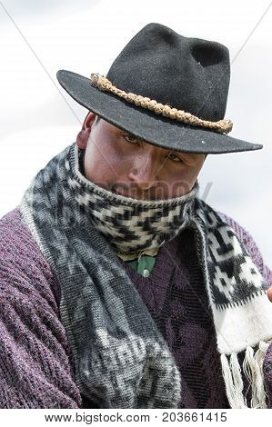 June 10 2017 Toacazo Ecuador: closeup of an indigenous cowboy wearing a shal in the cold morning of the high altitude Andes