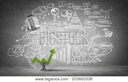 Lightbulb with green growing graph inside placed against sketched business plan information on grey wall. 3D rendering.